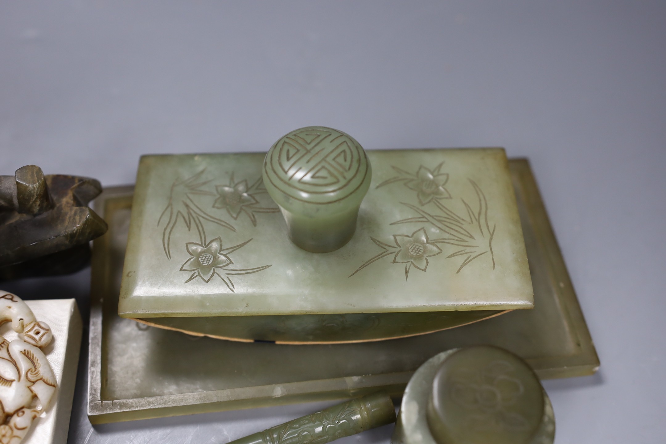 A Chinese bowenite jade desk set (7) and a plaque, model of junk 16cms high